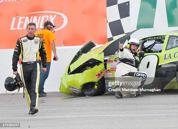 Ryley Seibert, driver of the No. 09 Lake Excavating/EMCO Waterworks Dodge is directed away from the car of Ray Courtemanche Jr., driver of the No. 29...