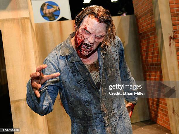 Zombie character poses at the booth for the television series "The Walking Dead" during Comic-Con International 2013 at the San Diego Convention...