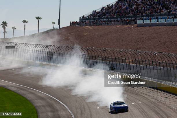 Kyle Larson, driver of the HendrickCars.com Chevrolet, celebrates with a burnout after winning the NASCAR Cup Series South Point 400 at Las Vegas...