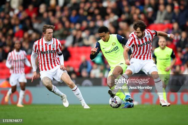 Jobe Bellingham of Sunderland is challenged by Ben Pearson of Stoke City during the Sky Bet Championship match between Stoke City and Sunderland at...