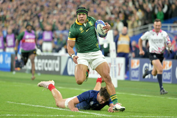 Cheslin Kolbe of South Africa beats Damian Penaud of France to score his team third try during the Rugby World Cup France 2023 Quarter Final match...