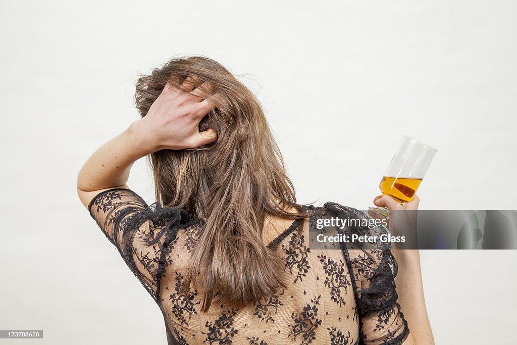 Young woman with a glass of liquor