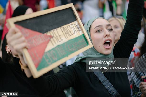Demonstrator holds a board with the lettering reading 'Free Palestine' during a rally in solidarity with Palestinians in the Gaza Strip organised by...