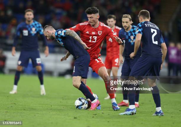 Josip Stanisic of Croatia is challenged by Kieffer Moore of Wales during the UEFA EURO 2024 European qualifier match between Wales and Croatia at...