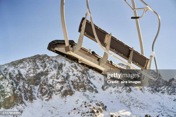 low angle view of an empty chairlift with no people moving on the cable, with the sky in the background - andorra people stock pictures, royalty-free photos & images