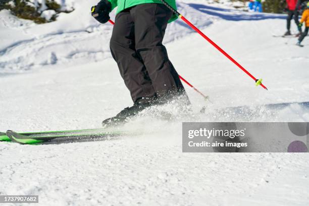 legs of a person on a snowboard practicing ski splashing in close-up, side view. - snowboard jump close up stock pictures, royalty-free photos & images