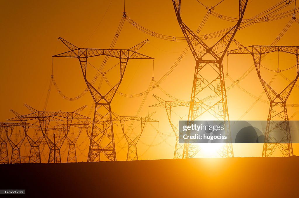 Silhouetted electricity pylon grid