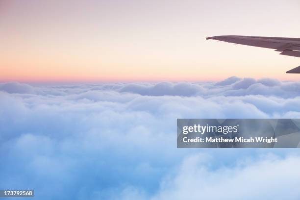 soft clouds blanket the sky during flight - aircraft wing stock pictures, royalty-free photos & images