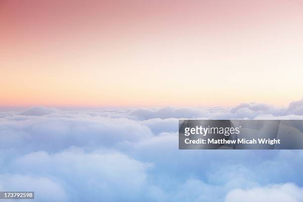 soft clouds blanket the sky during flight - wolkengebilde stock-fotos und bilder