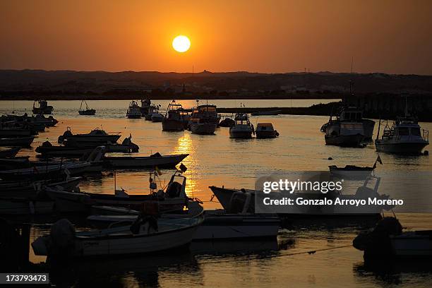 Fishing boats and dinghies at sunset at Barriada Canela port, the Ayamonte neighbourhood were most of the illegal fishermen live on June 28, 2013 in...