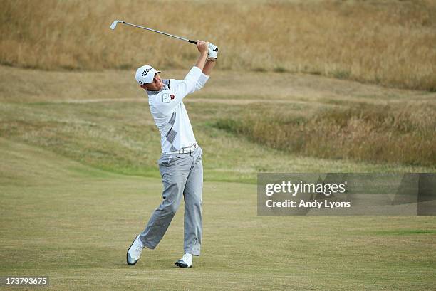 Lloyd Saltman of Scotland hits his second shot on the 6th hole during the first round of the 142nd Open Championship at Muirfield on July 18, 2013 in...