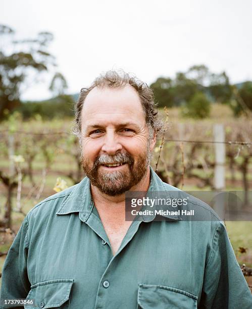 man smiling at camera in vineyard - australian portrait stock-fotos und bilder