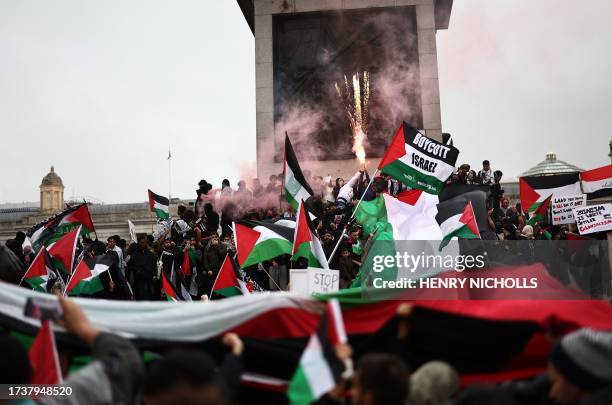 People take part in a 'March For Palestine', in London on October 21 to "demand an end to the war on Gaza". The UK has pledged its support for Israel...