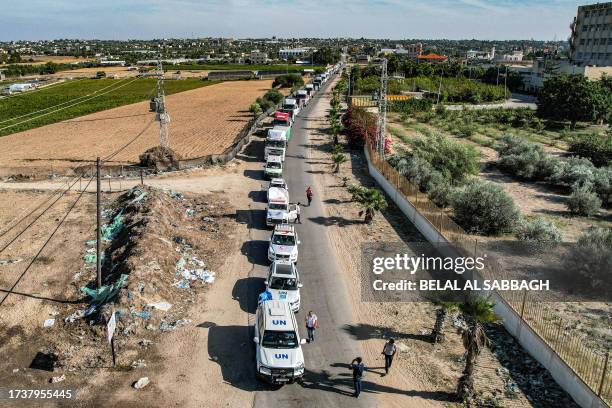 This aerial view shows humanitarian aid trucks arriving from Egypt after having crossed through the Rafah border crossing arriving at a storage...