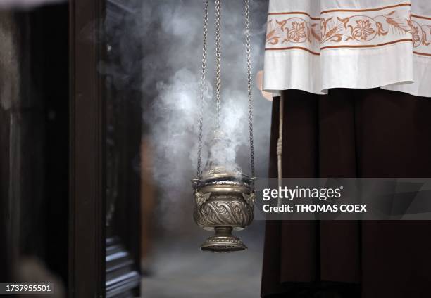 Franciscans friar uses a censer during a procession dedicated to peace in Israel and Gaza, at the Holy Sepulchre Church in the Old City of Jerusalem,...