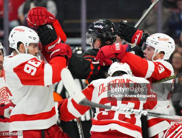 Brady Tkachuk of the Ottawa Senators pushes and shoves with Jake Walman, Alex DeBrincat and Lucas Raymond of the Detroit Red Wings at Canadian Tire...