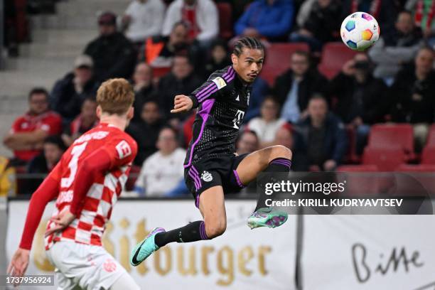 Bayern Munich's German forward Leroy Sane controls the ball as he vies with Mainz' Dutch defender Sepp van den Berg during the German first division...