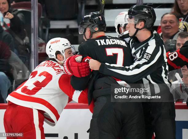 Brady Tkachuk of the Ottawa Senators pushes and shoves with Alex DeBrincat of the Detroit Red Wings at Canadian Tire Centre on October 21, 2023 in...