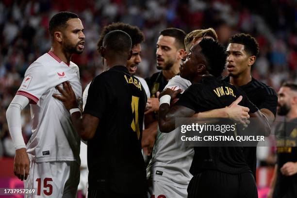 Real Madrid's Brazilian forward Vinicius Junior argues with Sevilla's Moroccan forward Youssef En-Nesyri during the Spanish league football match...