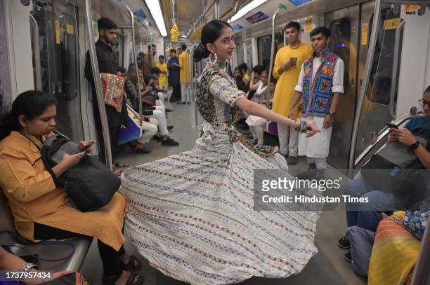 People perform Garba dance on the occasion of the first day of Navratri festival inside Maha Mumbai Metro train, on October 21, 2023 in Mumbai, India.