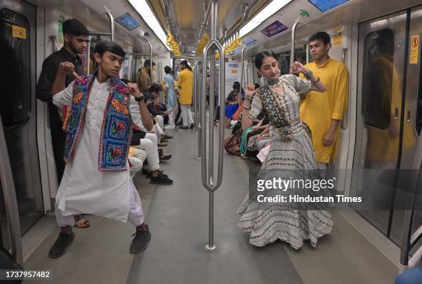 People perform Garba dance on the occasion of the first day of Navratri festival inside Maha Mumbai Metro train, on October 21, 2023 in Mumbai, India.