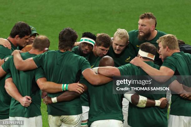 South Africa's players form a huddle at the as South Africa's blindside flanker and captain Siya Kolisi addresses the group at the end of the warm up...