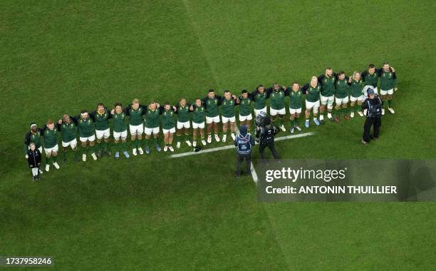 South Africa's blindside flanker and captain Siya Kolisi leads his players line up for the playing of the national anthems ahead of the France 2023...