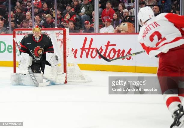 Spartacat of the Ottawa Senators watches as Joonas Korpisalo makes a save against Olli Maatta of the Detroit Red Wings at Canadian Tire Centre on...