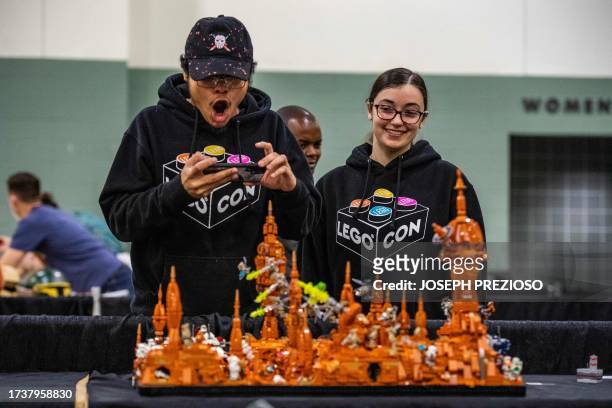 People inspect custom built brick creations at Brick Fest Live in Worcester, Massachusetts on October 21, 2023. The convention is a showcase and fan...