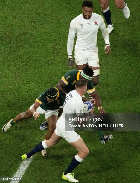 England's full-back Freddie Steward is tackled by South Africa's right wing Kurt-Lee Arendse and South Africa's blindside flanker and captain Siya...