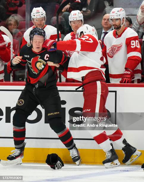 Brady Tkachuk of the Ottawa Senators fights with Michael Rasmussen of the Detroit Red Wings at Canadian Tire Centre on October 21, 2023 in Ottawa,...