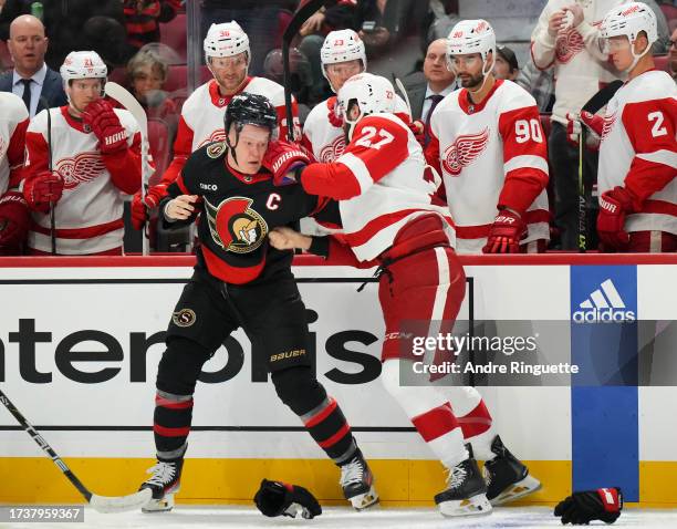 Brady Tkachuk of the Ottawa Senators fights with Michael Rasmussen of the Detroit Red Wings at Canadian Tire Centre on October 21, 2023 in Ottawa,...