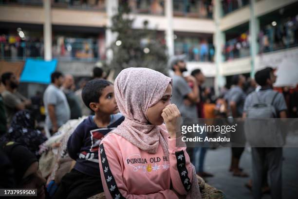 Palestinians taking refuge in a UNRWA school panic after an Israeli airstrike hits a house across the road in Khan Yunis, Gaza on October 21, 2023.