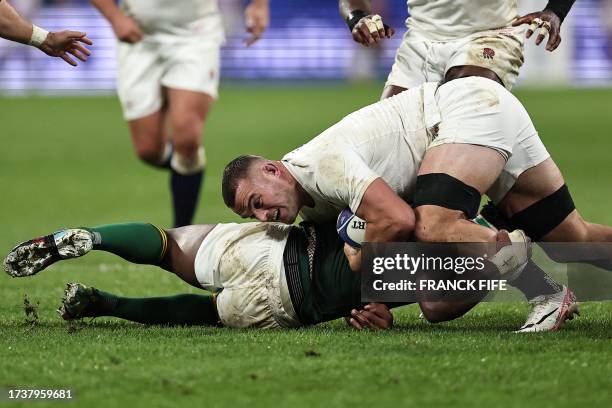 England's number eight Ben Earl is tackled by South Africa's blindside flanker and captain Siya Kolisi during the France 2023 Rugby World Cup...
