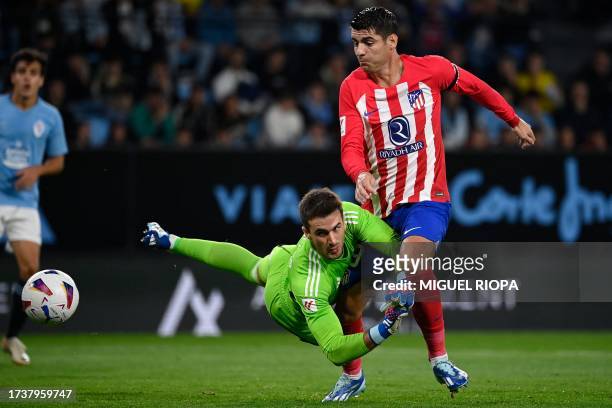 Atletico Madrid's Spanish forward Alvaro Morata challenges Celta Vigo's Spanish goalkeeper Ivan Villar during the Spanish league football match...