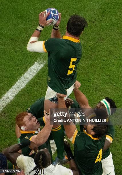 South Africa's lock Franco Mostert grabs the ball in a line out as South Africa's blindside flanker and captain Siya Kolisi looks on during the...