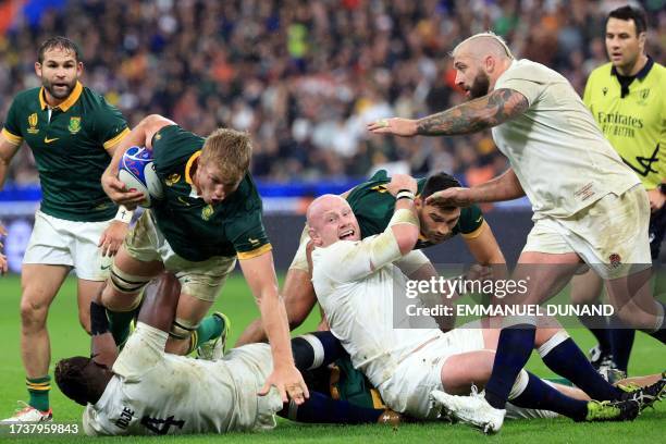 South Africa's openside flanker Pieter-Steph du Toit falls to the ground over England's lock Maro Itoje during the France 2023 Rugby World Cup...