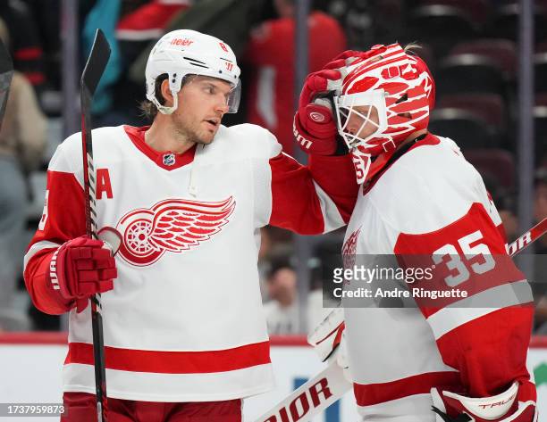 Ben Chiarot of the Detroit Red Wings congratulates Ville Husso after their teams' 5-2 win against the Ottawa Senators at Canadian Tire Centre on...