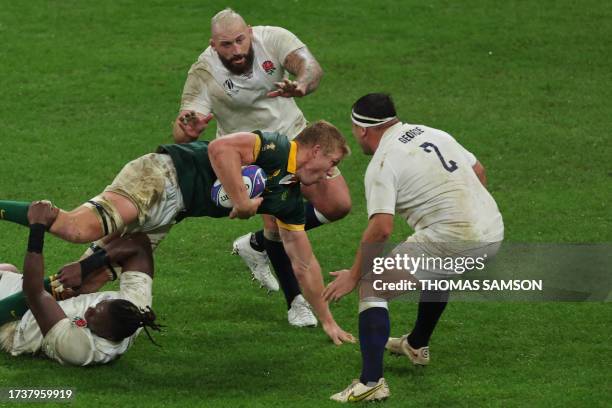 South Africa's openside flanker Pieter-Steph du Toit is tackled by England's lock Maro Itoje during the France 2023 Rugby World Cup semi-final match...