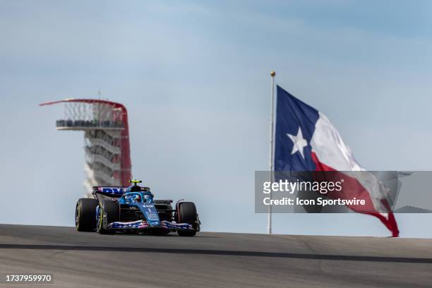 Alpine F1 Team driver Pierre Gasly of France speeds through turn 10 with the COTA Tower and the Texas flag in the background during the sprint...
