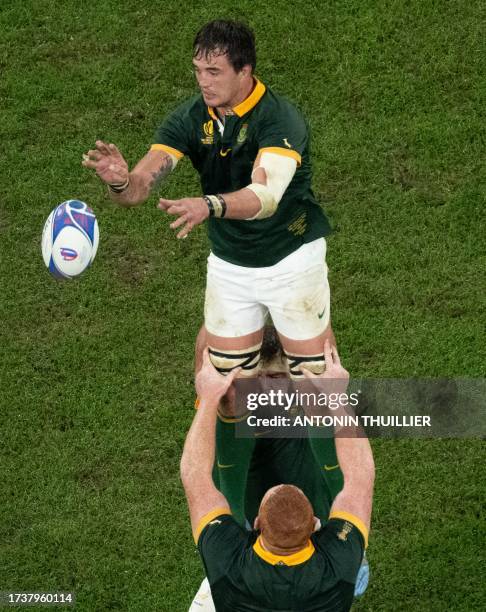 South Africa's lock Franco Mostert grabs the ball in a line out held aloft by South Africa's tighthead prop Frans Malherbe and South Africa's...