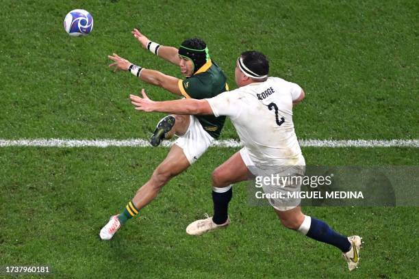 England's hooker Jamie George attempts to charge down a kick from South Africa's left wing Cheslin Kolbe during the France 2023 Rugby World Cup...