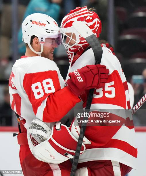Daniel Sprong of the Detroit Red Wings congratulates Ville Husso after their teams' 5-2 win against the Ottawa Senators at Canadian Tire Centre on...