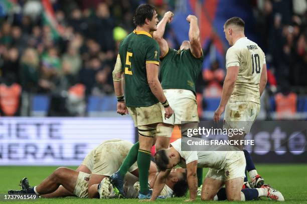South Africa's lock Franco Mostert and South Africa's openside flanker Pieter-Steph du Toit react after South Africa won the France 2023 Rugby World...