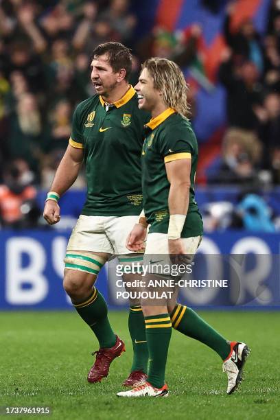 South Africa's scrum-half Faf de Klerk and South Africa's back row Kwagga Smith celebrate South Africa's victory as they walk off the pitch at the...