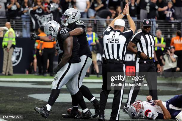 Bilal Nichols of the Las Vegas Raiders and Adam Butler of the Las Vegas Raiders celebrate after a sack by Butler and Maxx Crosby of the Las Vegas...