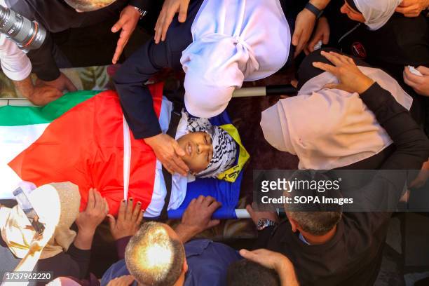 Relatives mourn over the body of 17-year-old Oday Mansour, a day after he was killed during clashes with Israeli soldiers at a military checkpoint...