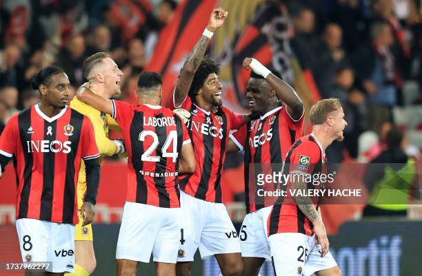 Nice's Brazilian defender Dante celebrates with teammates after winning the French L1 football match between OGC Nice and Marseille OM at the Allianz...