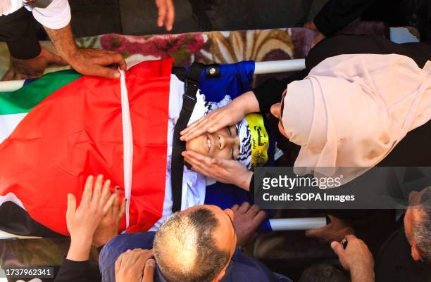 Mother mourns over the body of 17-year-old Oday Mansour, a day after he was killed during clashes with Israeli soldiers at a military checkpoint near...