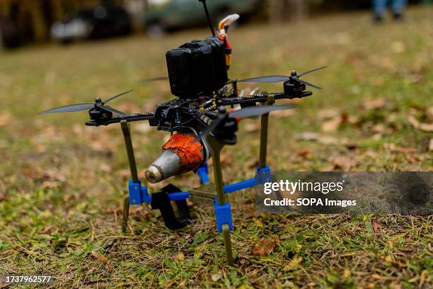 View of a drone loaded with a dummy bomb, placed on the ground ready to be used during the training.